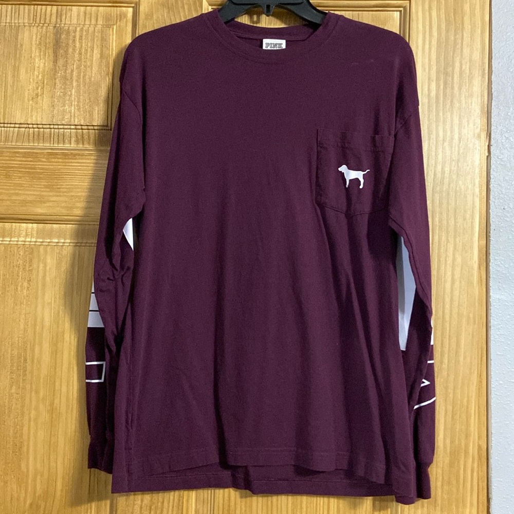 Pink long sleeve with pocket on the front and the word “pink” on each sleeve